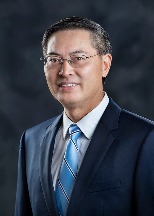 Portrait of Chuji Wang wearing coat and tie