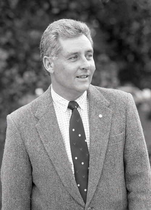 Wayne Weidie, pictured wearing a suit and tie outside.