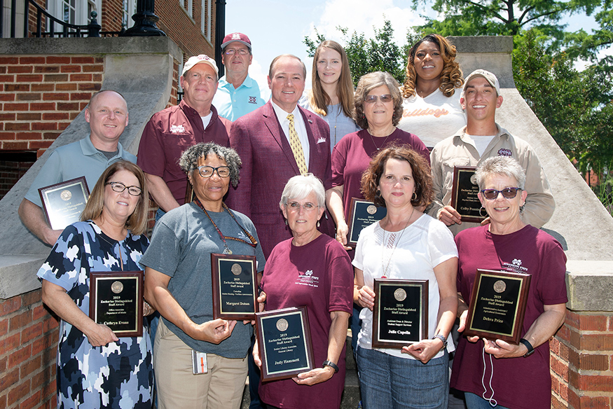 MSU President Mark E. Keenum (middle row, center) congratulates the university’s newest Zacharias Distinguished Staff Award winners. Recognized Friday [May 17] during the university’s annual Staff Appreciation Day, honorees include (front, l-r) Cathy Evans, Margaret Dotson, Judy Hammett, Julie Capella and Debra Price; (middle, l-r) Marc Measells, Ken Stewart, Keenum, Debbie Wade and Colby Pennington; (back, l-r) Wayne Philley, Amelia Rogers and Vemitra White. (Photo by Beth Wynn)