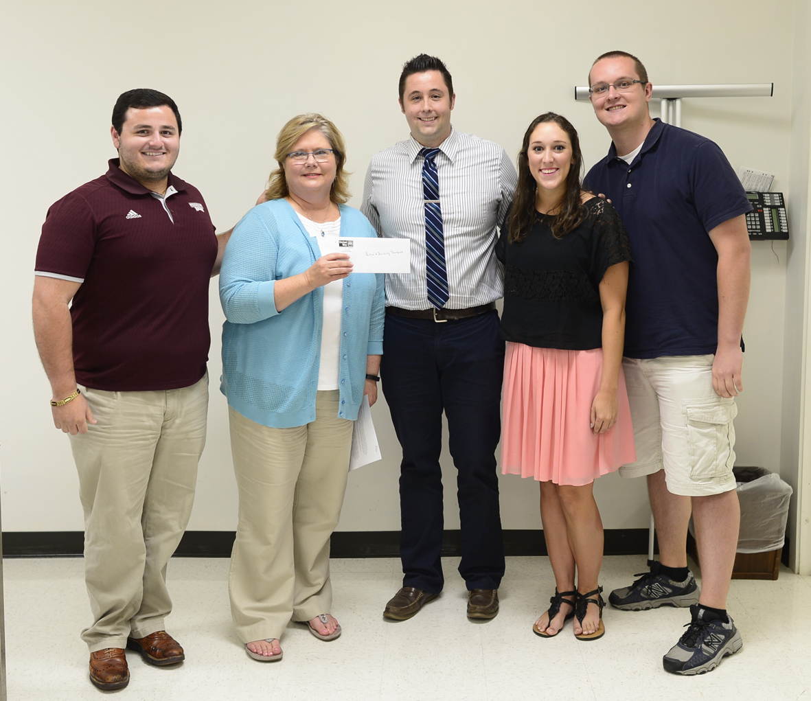 Robyn Havard (second from left), executive committee chair of the Starkville-based United Way of North Central Mississippi, recently presented an $8,000 check to MSU’s Autism and Development Disabilities Clinic. Accepting were (from left) Alex Clarke, Dan Gadke, Margaret Bernheim and Adam Weseloh. Gadke, an assistant professor of psychology, is clinic director, while the others are graduate students working there. (Photo submitted)