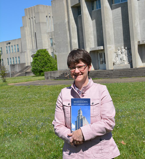 Jennifer Baughn holds a copy of "Buildings of Mississippi"