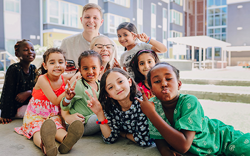 Baron O. Necaise of Gulfport, an MSU architecture student who interned this summer with Method Studio in Salt Lake City, Utah, is pictured with children who live in the Bud Bailey multi-family affordable housing project