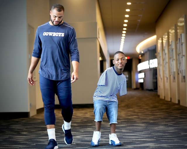 Dak Prescott and Kendrell Daniels are pictured together during a visit in which Daniels presented Prescott with some of his artwork he created through the Express Yourself program at Mississippi State’s T.K. Martin Center for Technology and Disability. (Photo by Deborah Stuart/ESPN) 