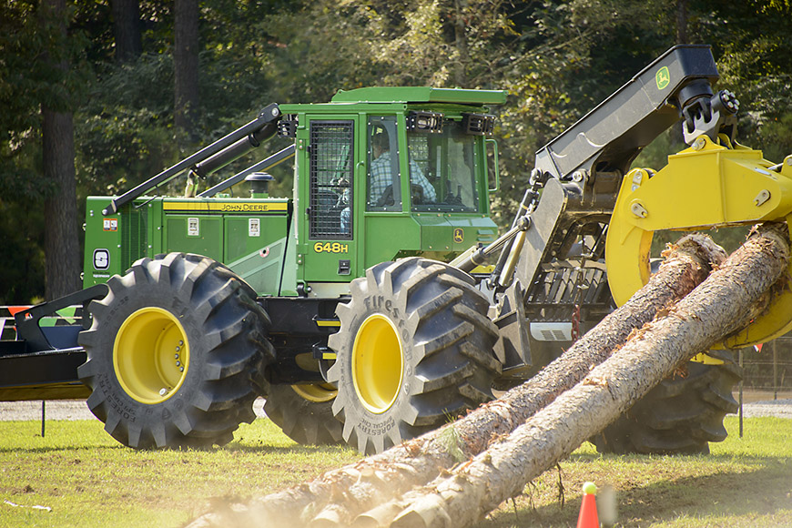 A 2014 attendee competes in the skidder contest sponsored by John Deere and Stribling Equipment . (Photo by David Ammon)