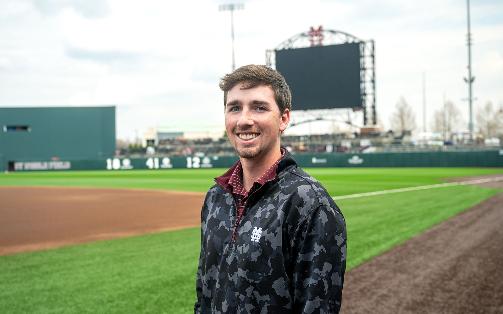 young man standing on a baseball field