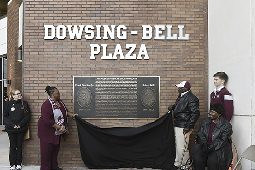 Virginia Toliver, the sister of Frank Dowsing Jr., and Robert Bell unveil the new plaque at Dowsing-Bell Plaza at Davis Wade Stadium. The plaza honors the legacy of Dowsing and Bell, the first two African-American student-athletes at MSU. (Photo by Beth Wynn)