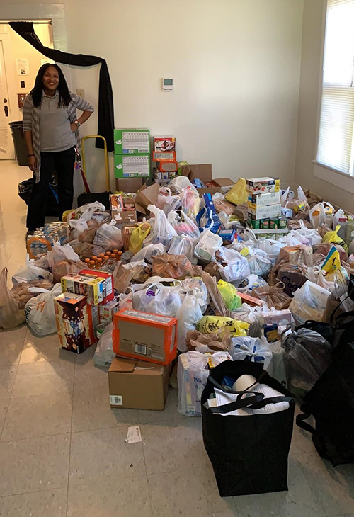 Latice Fisher, an AmeriCorps VISTA (Volunteers in Service to America) for Bully’s Closet and Pantry, is pictured accepting a recent truck-bed sized donation of food and other essential supplies for MSU students at the 120 Morgan Ave. location. 