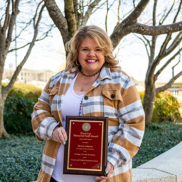 Shawna Johnson holding an award