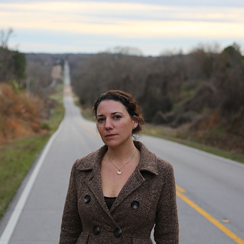 Mary Miller, pictured standing on a hilly road.