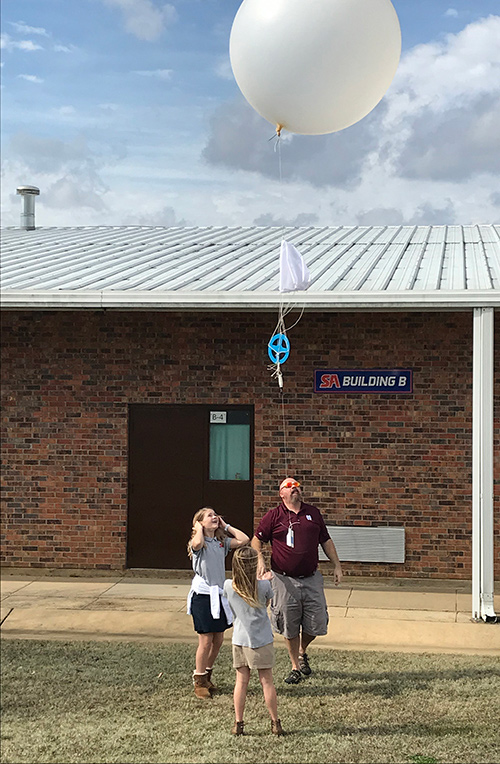 Mississippi State University professor and State of Mississippi climatologist Michael Brown launched a weather balloon with fifth grade students at Starkville Academy Thursday [Feb. 7]. (Photo submitted)
