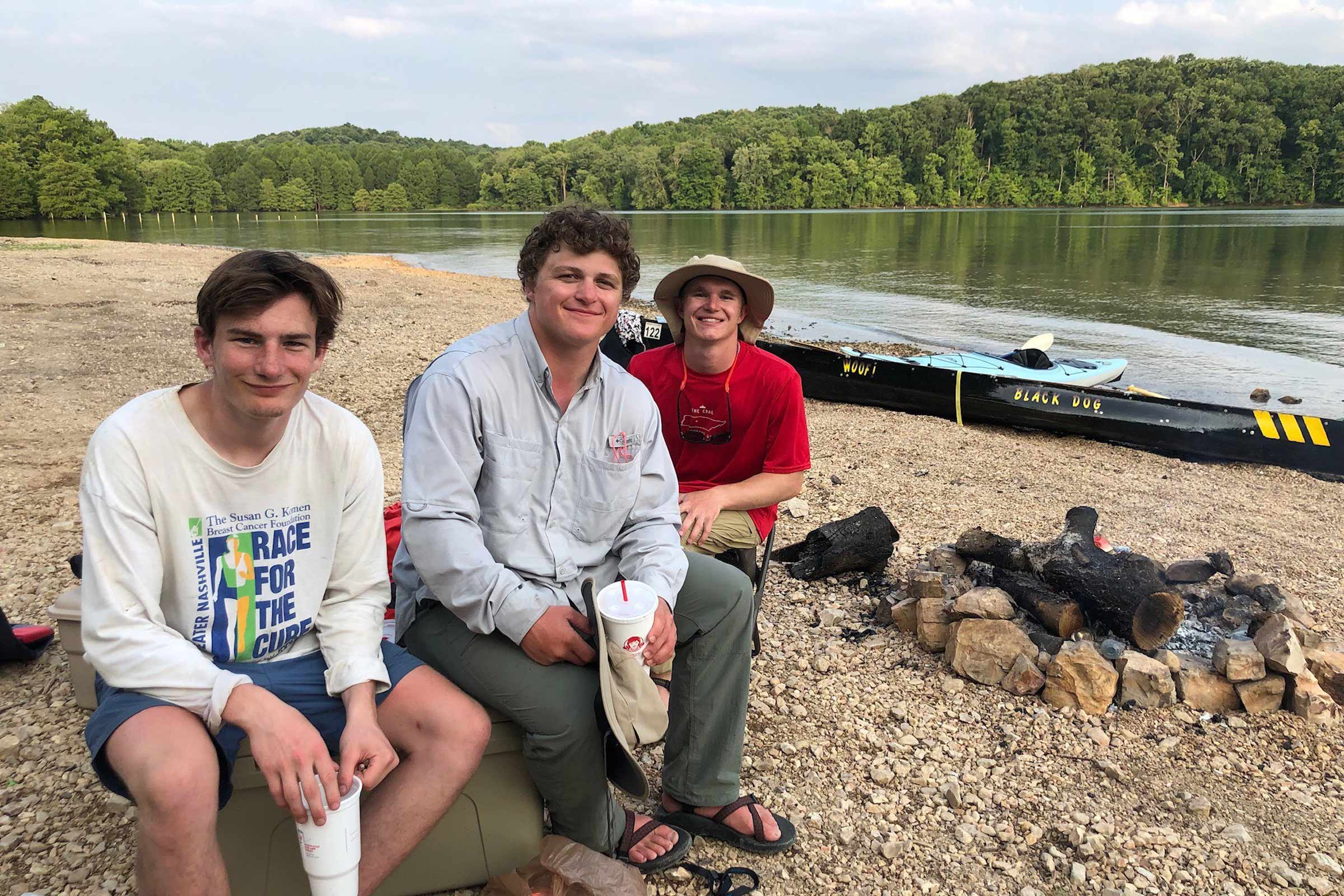 Job, Jonah and Luke, pictured on a river bank next to their canoes.