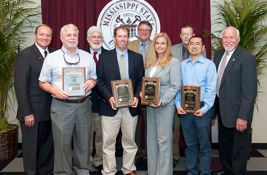 Mississippi State scientists who were awarded patents in Fiscal Year 2015 were recognized during Mississippi State's annual research awards banquet Thursday [April 28], and congratulated by MSU President Mark E. Keenum (left) and Bill Herndon (right), associate vice president for the Division of Agriculture, Forestry and Veterinary Medicine. They are (l-r) Phil Steele, Wayne McLaurin, Todd Byars, David Wise, Patricia Knight, Terry Greenway and Fei Yu. Not pictured: Brian Mitchell and Mark White. (Photo by Russ Houston)