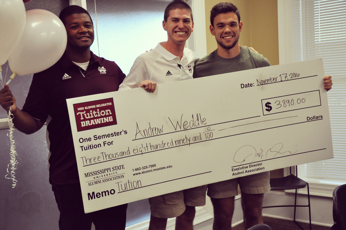 Tuition winner Andrew Weddle is congratulated by Alumni Delegate Daron Chandler, left, and Will Basden, incoming Alumni Delegates president. (Photo by Dipa Patel)