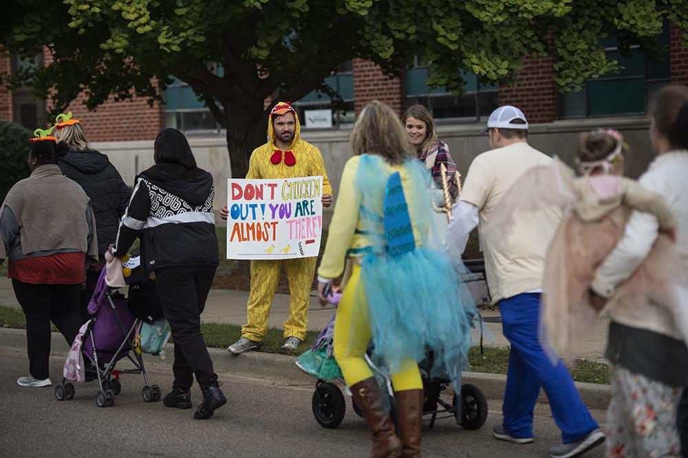 Supporters line the sidewalk and cheer on Trick or Trot participants.