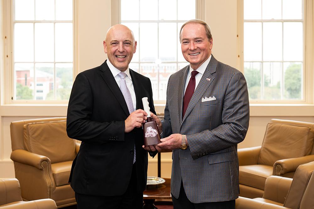 Robert Eikhoff, special agent in charge of the FBI’s Jackson Field Office, receives a cowbell from Mississippi State President Mark E. Keenum, right, Friday [Nov. 1] after touring numerous MSU research units.