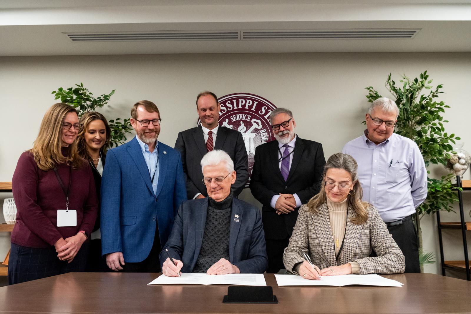 MSU Executive Vice Provost Peter Ryan and U.S. Naval Meteorology and Oceanography Naval Command Deputy Technical Director Jennifer Hailes mark the signing of an Educational Partnership Agreement between MSU and CNMOC. Also celebrating the expanded partnership between the two organizations is, from left, CNMOC Deputy Technical Director Kelly Wood, MSU Management and Information Systems Department Head Laura Marler, CNMOC Experimentation Lead Jason Pyron, MSU Dean for Integrative Studies and Northern Gulf Ins
