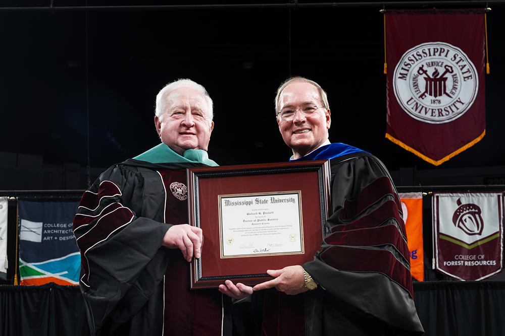 Puckett Machinery Company Chairman Richard H. Puckett Sr., left, receives a Doctor of Public Service honorary degree from MSU President Mark E. Keenum Friday [May 16] for his dedication and contributions to the university and state.