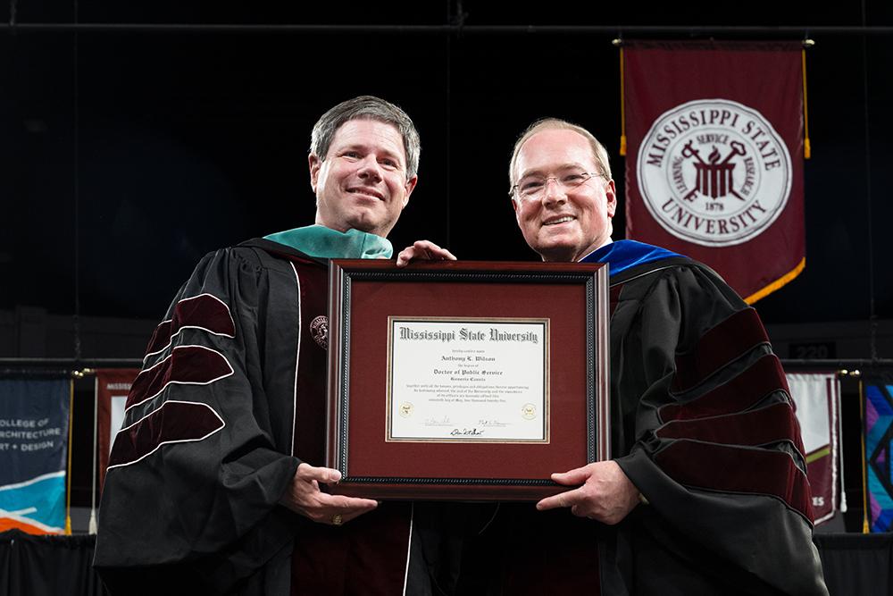 MSU President Mark E. Keenum, right, awards Mississippi Power Chief Executive Officer Anthony Wilson an honorary Doctor of Public Service degree in recognition of his continued support of the university and Magnolia State during Friday’s [May 16] afternoon commencement.