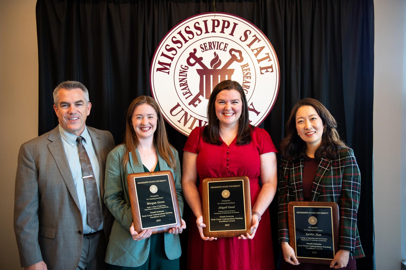 faculty pose with awards