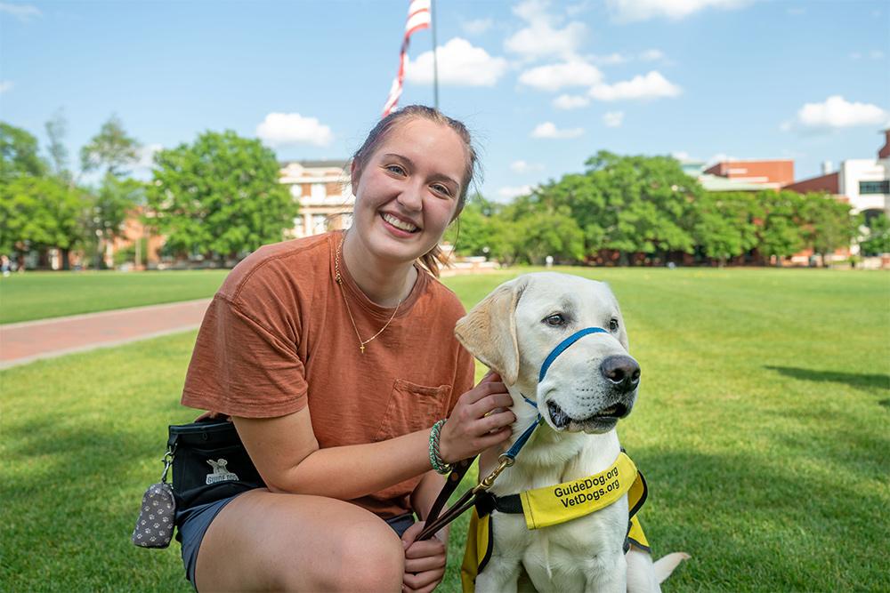 Hannah Pipkins, a sophomore art major from Petal, and yellow lab “Grippo” are part of Puppies with a Purpose at MSU.