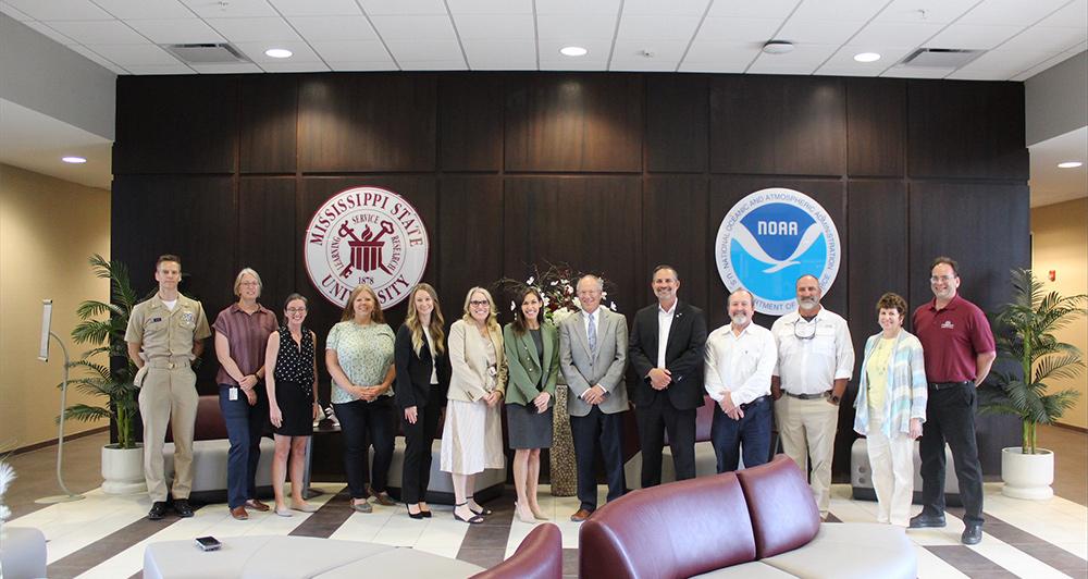 Laura Grimm (green jacket, center), visited with Mississippi State University and National Oceanic and Atmospheric Administration personnel during a recent visit to the MSU Science and Technology Center at Stennis Space Center.