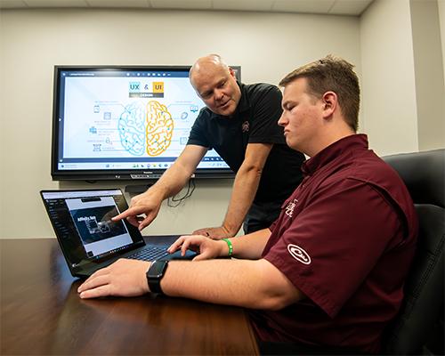 Greg Francom, associate professor of instructional design and LUX program coordinator, instructs Carter Peeples, an MSU senior ITS major from Brandon.