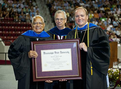 From right: Mississippi State President Mark E. Keenum and former Provost Jerry Gilbert present Richard Holmes with an honorary doctorate in 2011.
