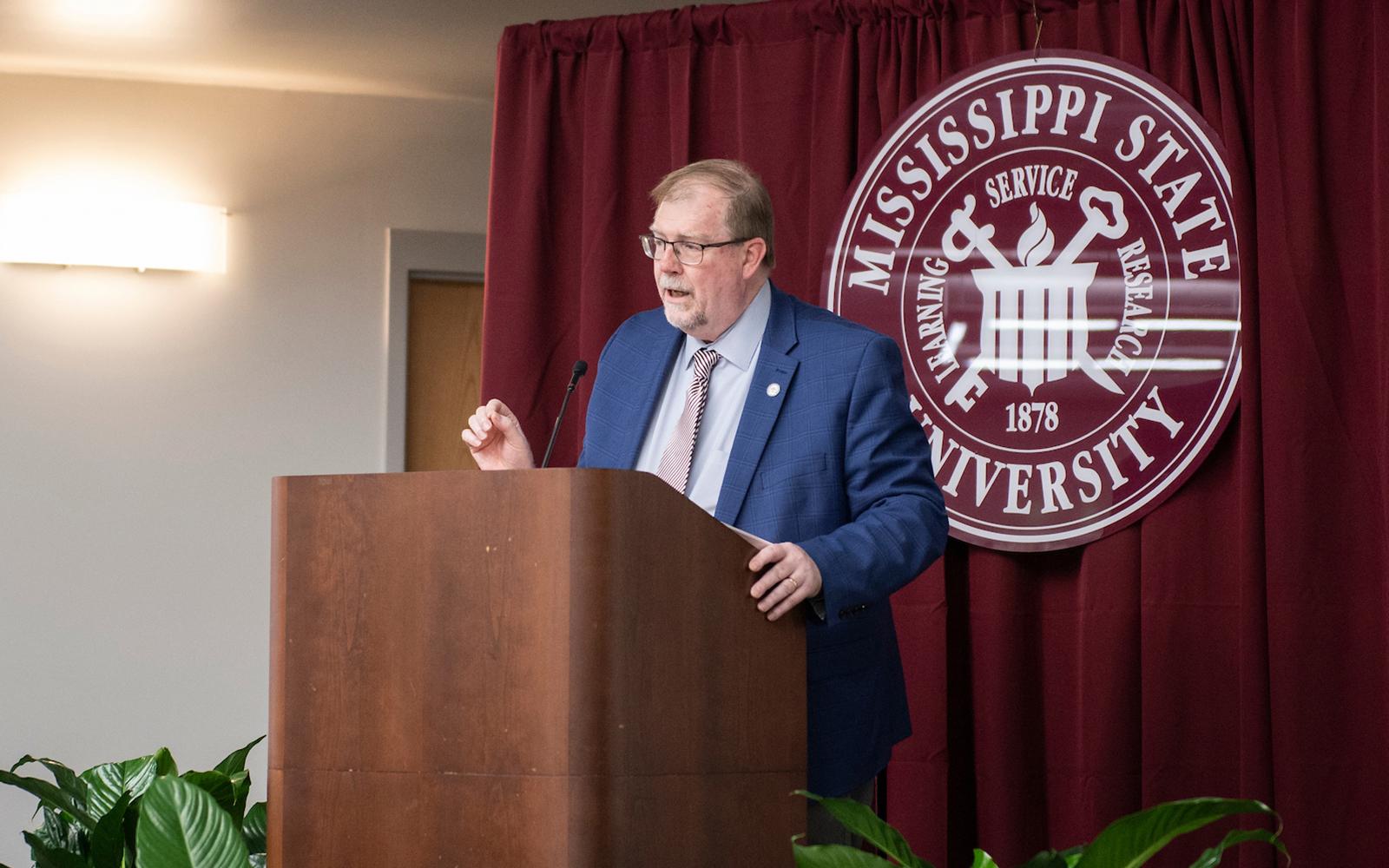Keith Coble speaks while standing at a podium during an MSU event.