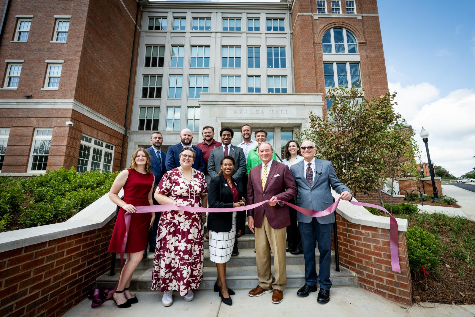 Group of university officials in front of ribbon cutting