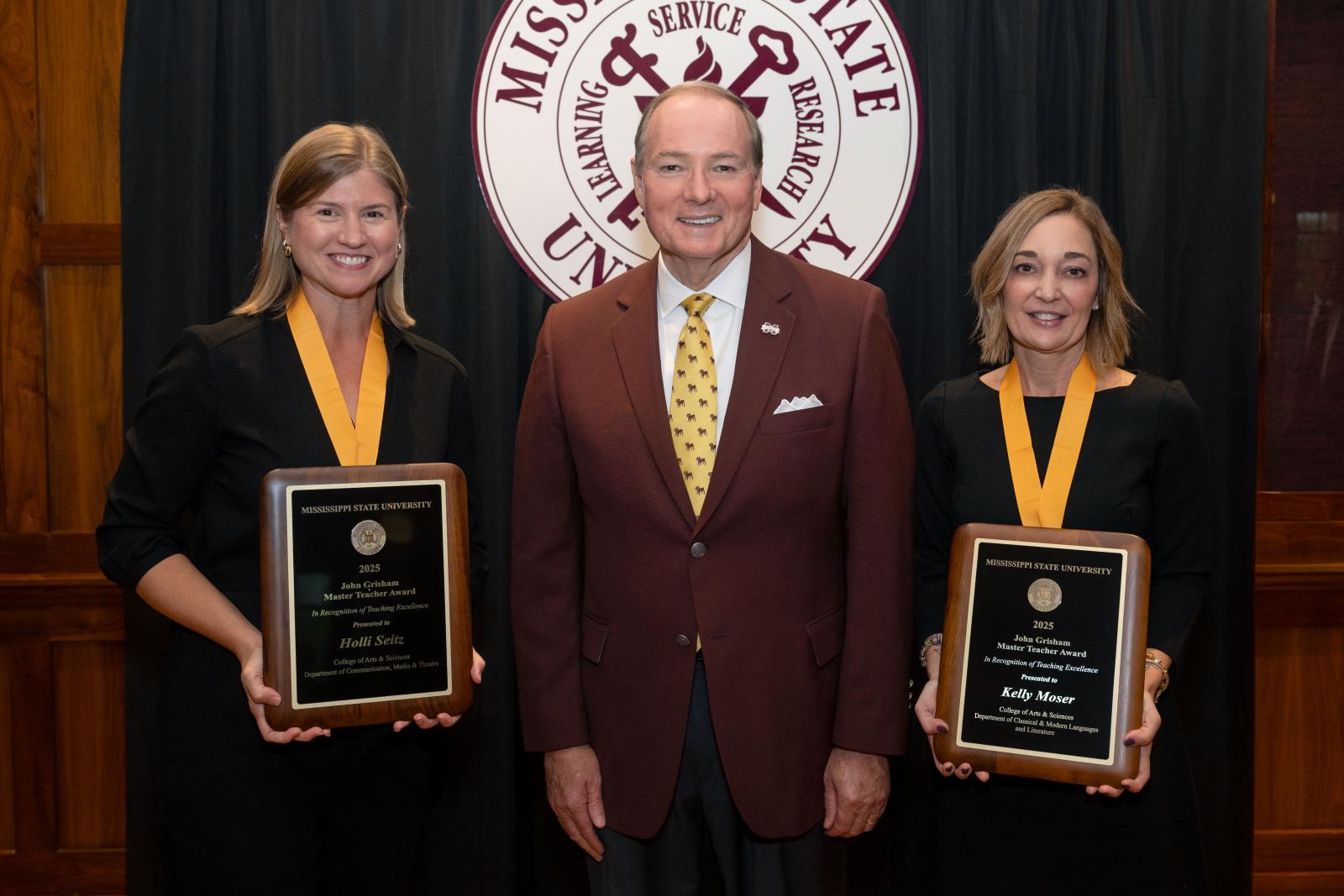 two women with awards posing with MSU president