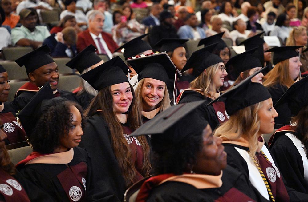 From left: Alexis Lowrey of Philadelphia and Emma Pitman of Dayton, Ohio, enjoy a moment during MSN graduation held Thursday [Aug. 7] at the MSU Riley Center in downtown Meridian.