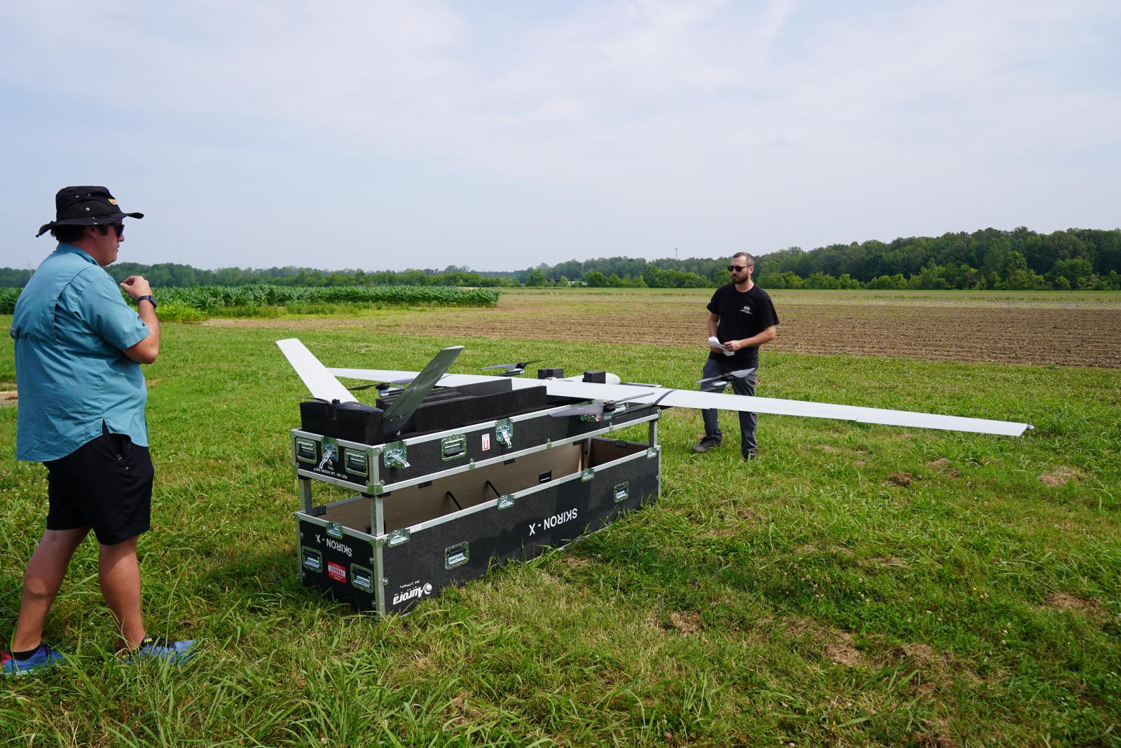 Raspet flight technician Charley Zera and an Aurora Flight Sciences engineer prepare the SKIRON-X platform for flight testing on MSU&#039;s North Farm.