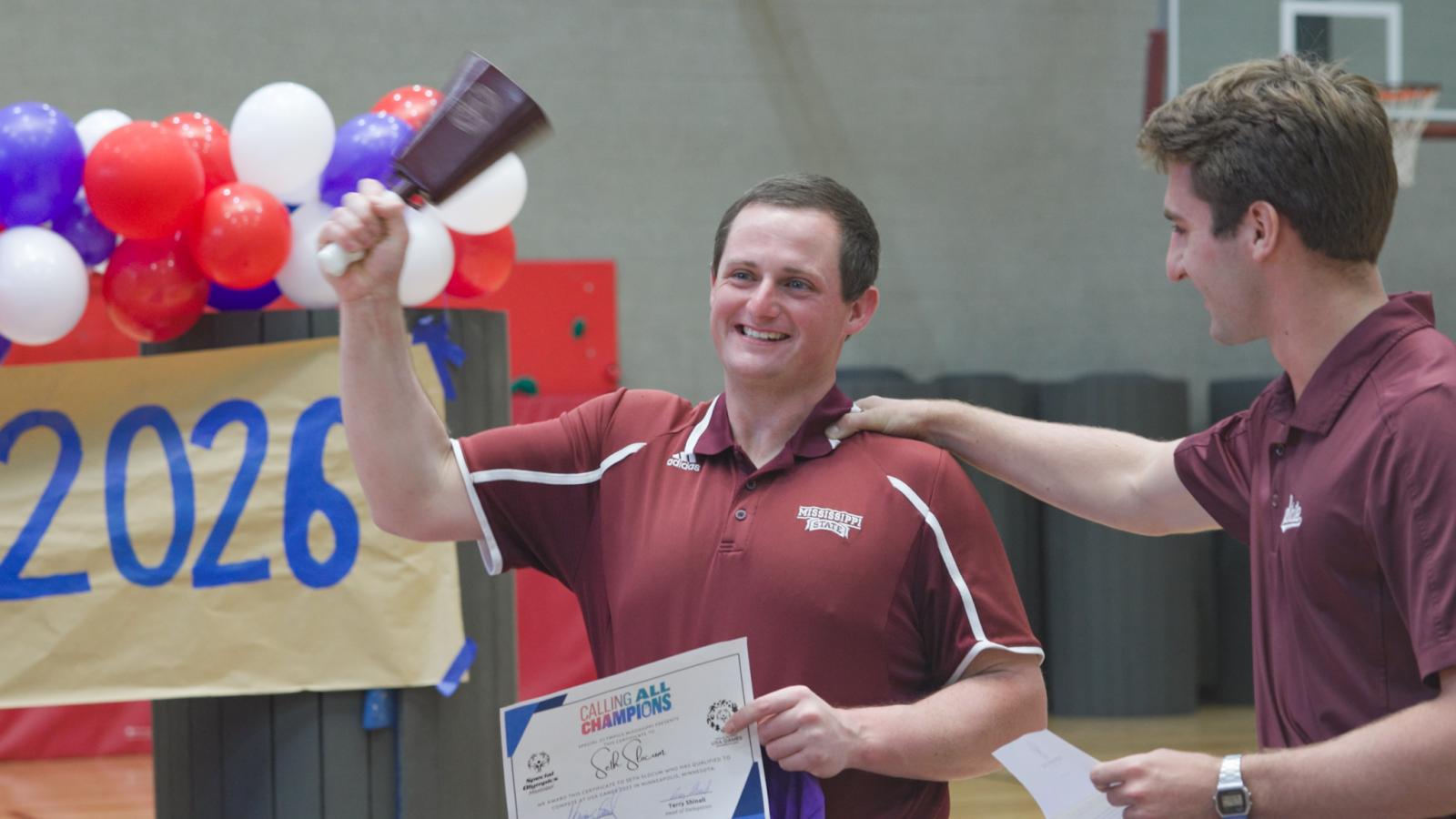 August Jones, right, congratulates Seth Slocum during a celebration in late August. Jones is an MSU student from Bay Springs and Unified weightlifting coach who helps with Slocum’s training as a powerlifter.