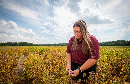 Elizabeth Worley stands in a field.