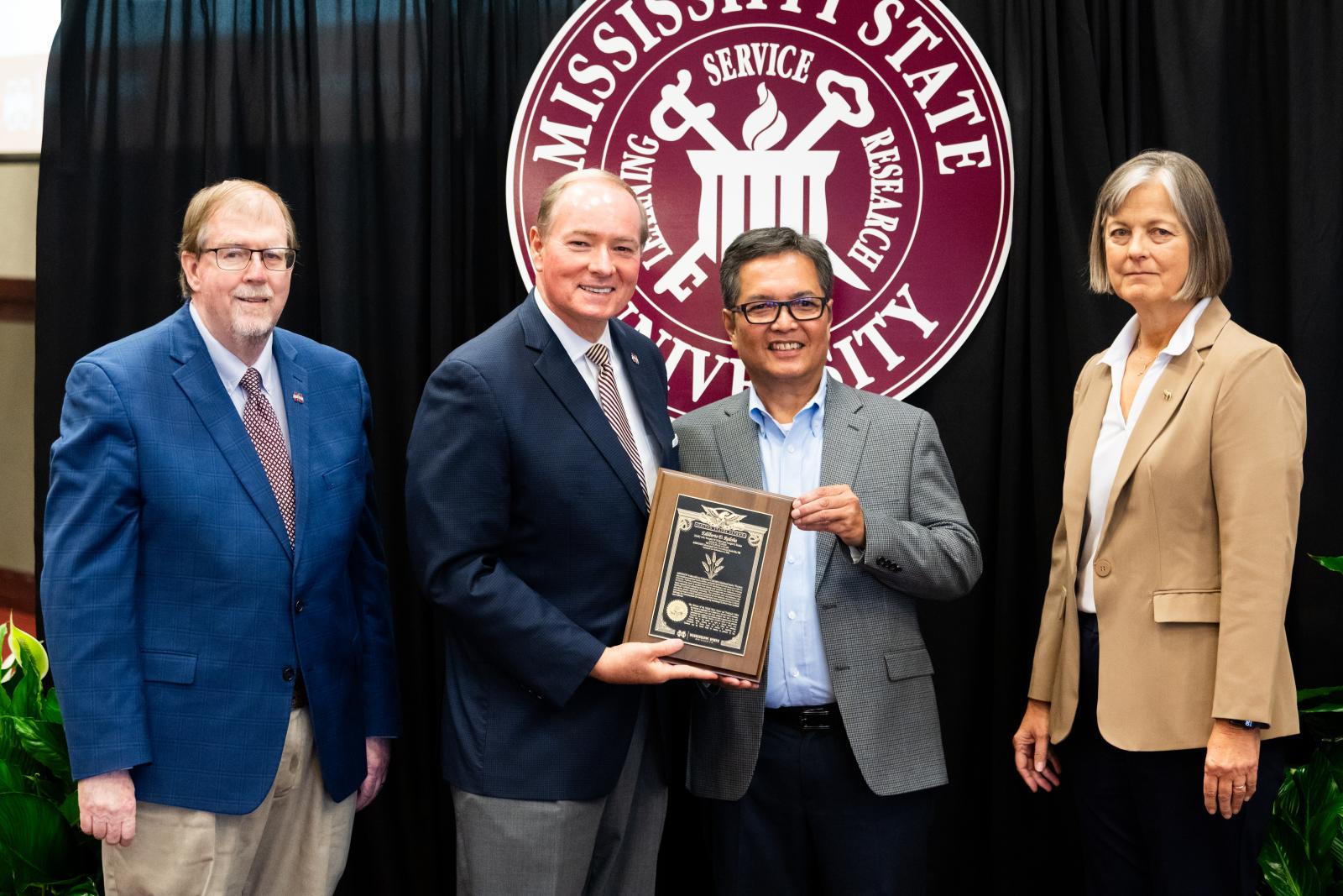 Vice President for DAFVM Keith Coble, MSU President Mark E. Keenum, Research Professor Edilberto Redona, and Vice President for Research and Economic Development Julie Jordan