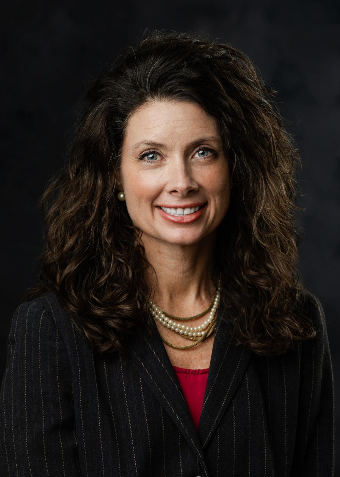 woman with brown hair on black background