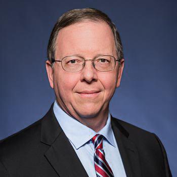 man with glasses on blue background
