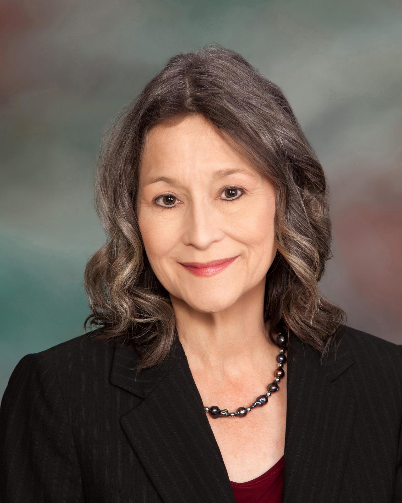 woman in black jacket on colorful background
