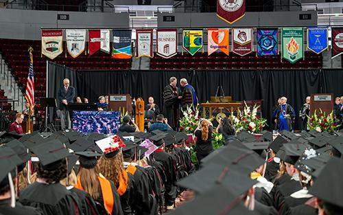 Students attend graduation ceremonies at Humphrey Coliseum.