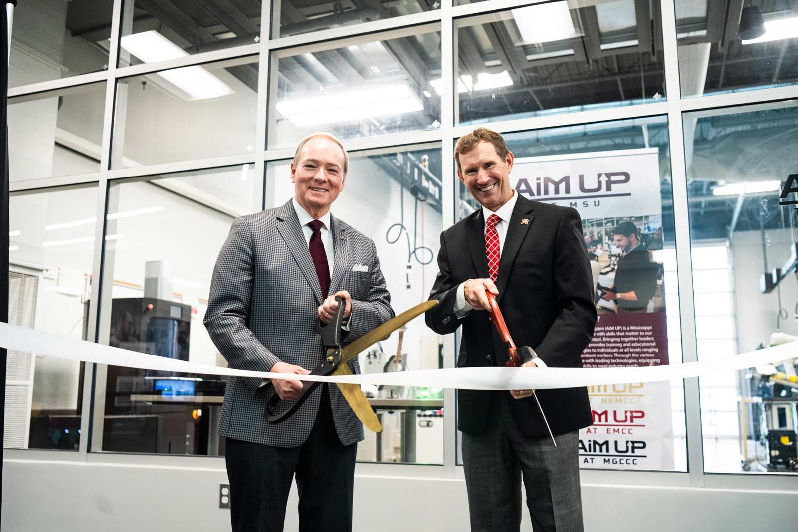 Mississippi State University President Mark E. Keenum, left, and East Mississippi Community College President Scott Alsobrooks cut the ribbon in January 2025 for the MSU at the Communiversity partnership through the Advancements in Manufacturing Upskilling Program, better known as AiM UP.