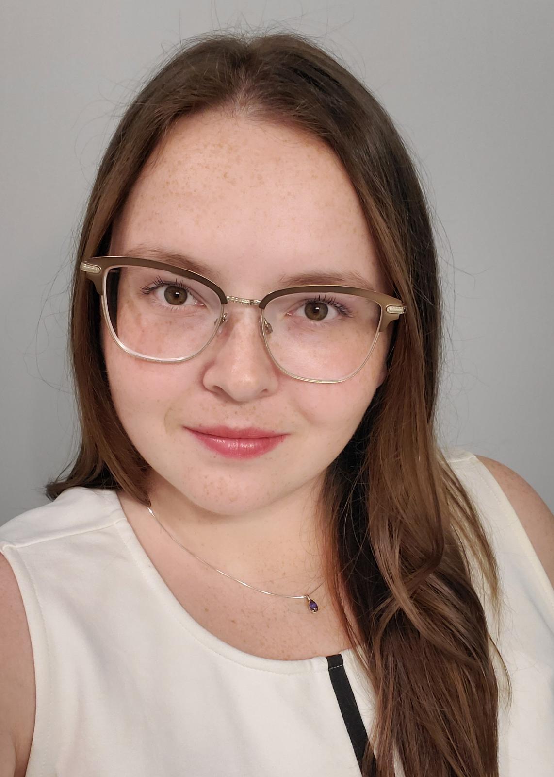 headshot of woman with brown hair on white background