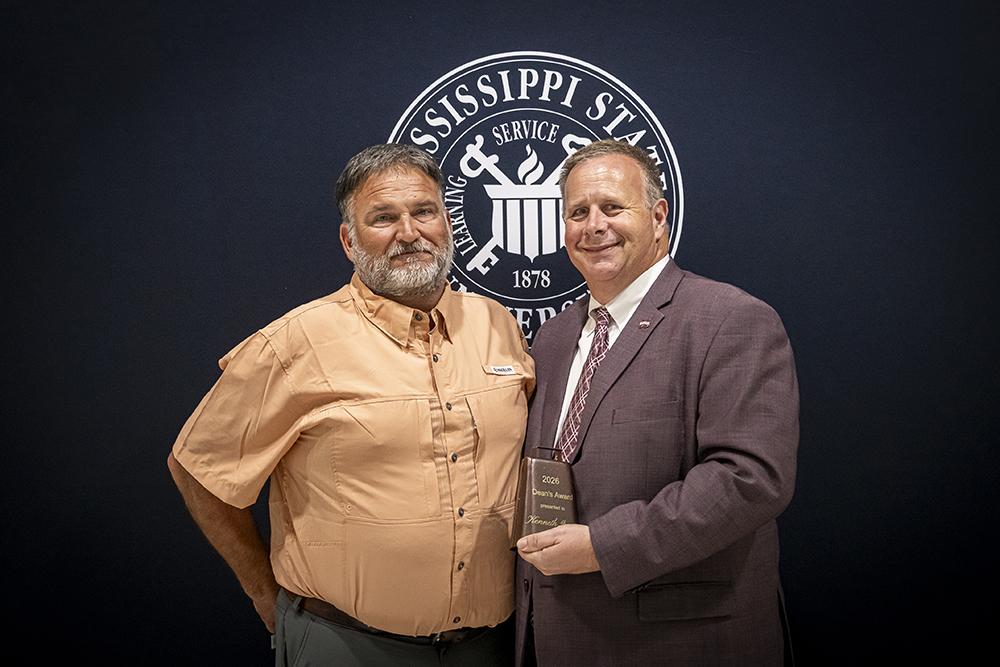 From left, Kenneth Graves, facilities manager in the Mississippi State Department of Animal and Dairy Sciences, accepts the MSU College of Agriculture and Life Sciences Dean’s Award from Scott Willard, CALS dean, MAFES director and interim vice president for research and economic development.