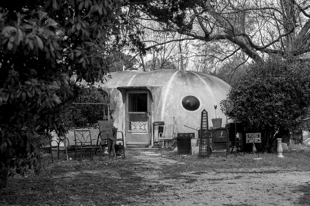 A photograph of a distinctive home with a rounded roof from the "Nettleton" photo exhibition