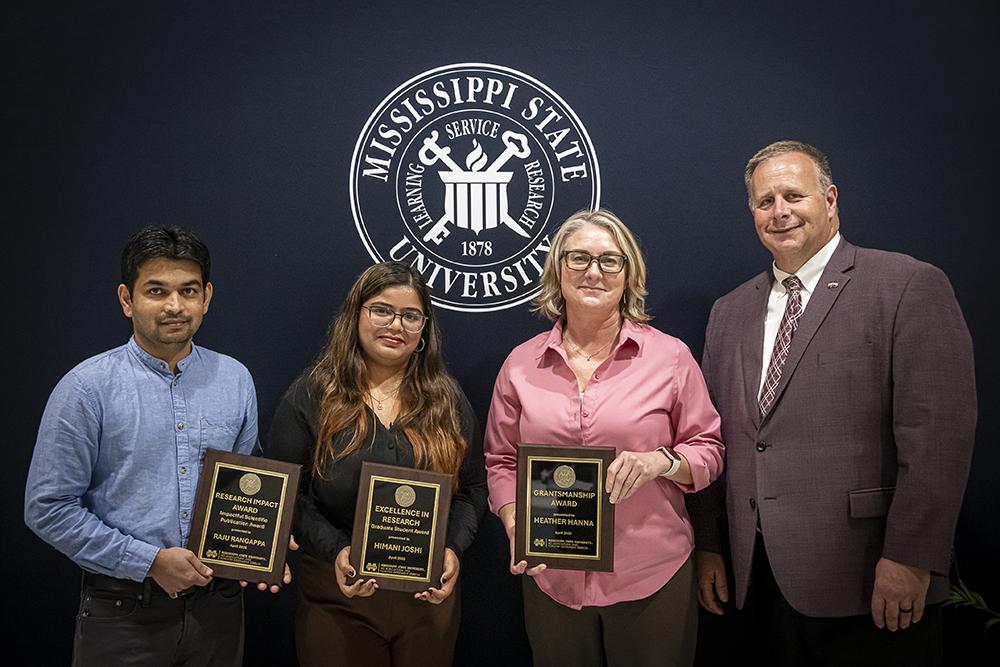 From left, Associate Research Professor Raju Bheemanahalli Rangappa, plant and soil sciences; Himani Joshi, doctoral student in animal and dairy sciences; and Associate Research Professor Heather Hanna, Social Science Research Center; with Scott Willard, CALS dean, MAFES director and interim vice president for research and economic development.