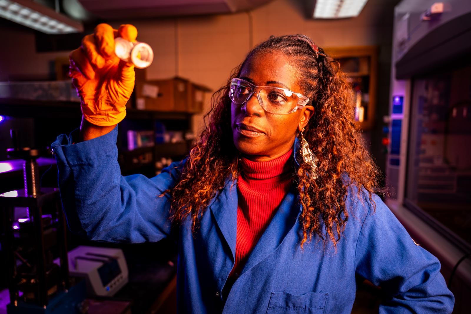 environmental portrait of colleen scott holding a test tube.