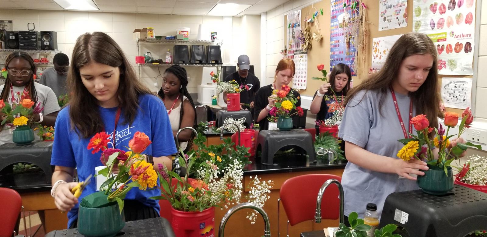 Photo of campers doing a floral arrangement.