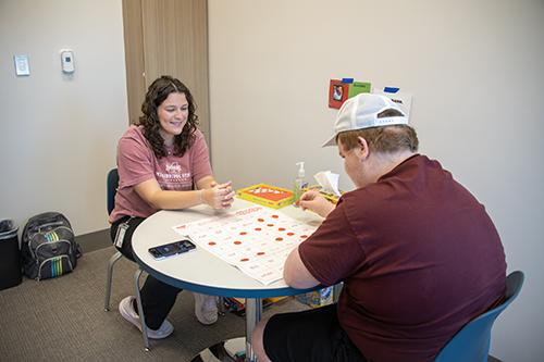 Maggie Stevens, an MSU applied behavior analysis senior and Registered Behavior Technician from Walnut Grove, works with Noah Kruse, right, from Starkville at MSU’s Autism and Developmental Disabilities Clinic in the Jim and Thomas Duff Center.
