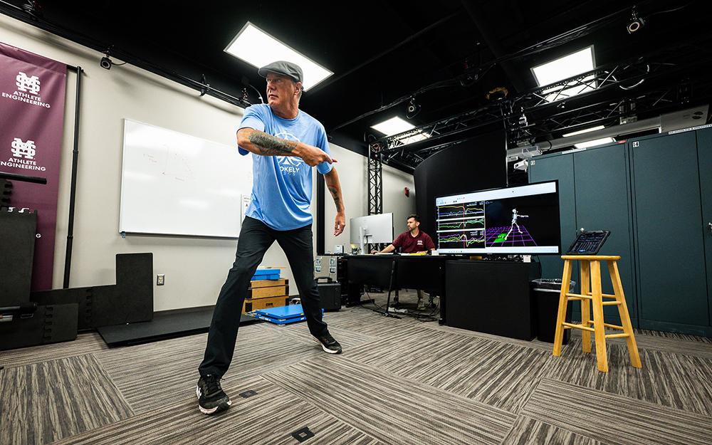 Scott Stokely, a disc golf hall of famer, throws a disc while the MSU Athlete Engineering Institute’s markerless motion capture system allows researchers to study his throwing motion.