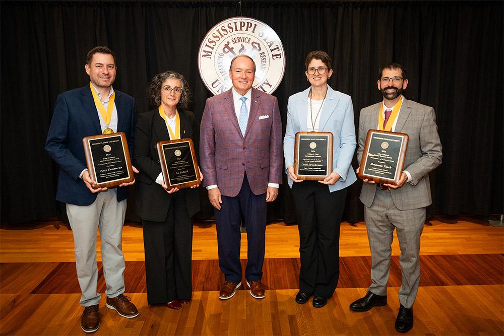 MSU President Mark E. Keenum, center, is pictured with Grisham Master Teacher award recipients from left Peter Summerlin, Iva Ballard, and Benjamin Tkach, far right, and William L. Giles Distinguished Professor Lesley Strawderman, second from right, at an awards ceremony..