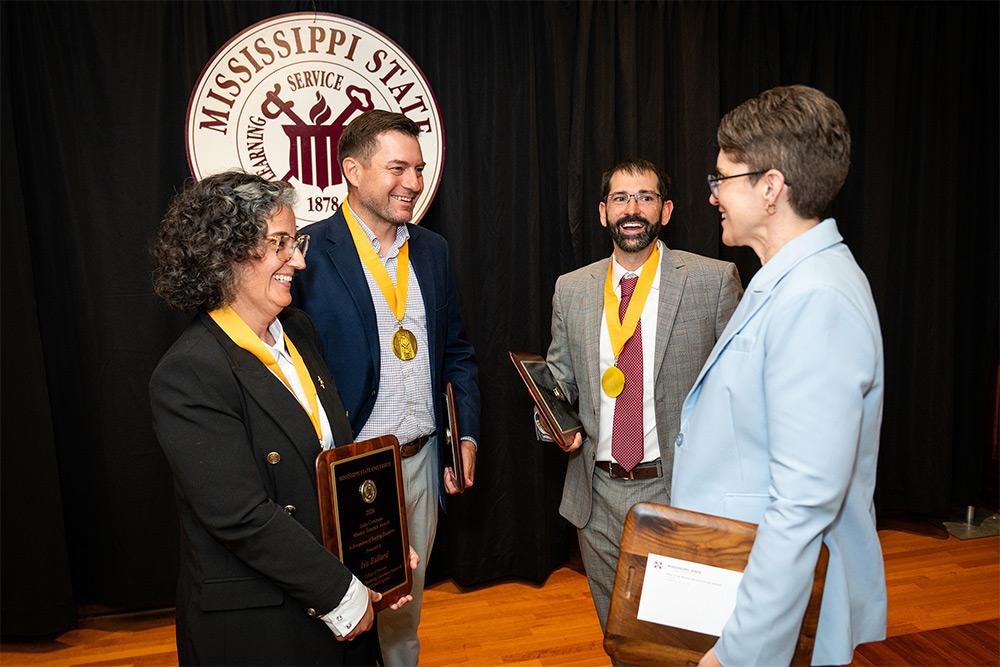 MSU’s newest John Grisham Master Teacher honorees Iva Ballard, Peter Summerlin and Benjamin Tkach, talk with the university’s newest Giles Distinguished Professor Lesley Strawderman.